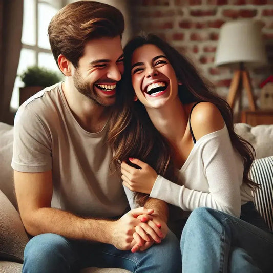 Man and woman laughing together on a sofa, illustrating gender dynamics in humor for article 'Laughter: Men vs. Women – Who Laughs More and Why?'