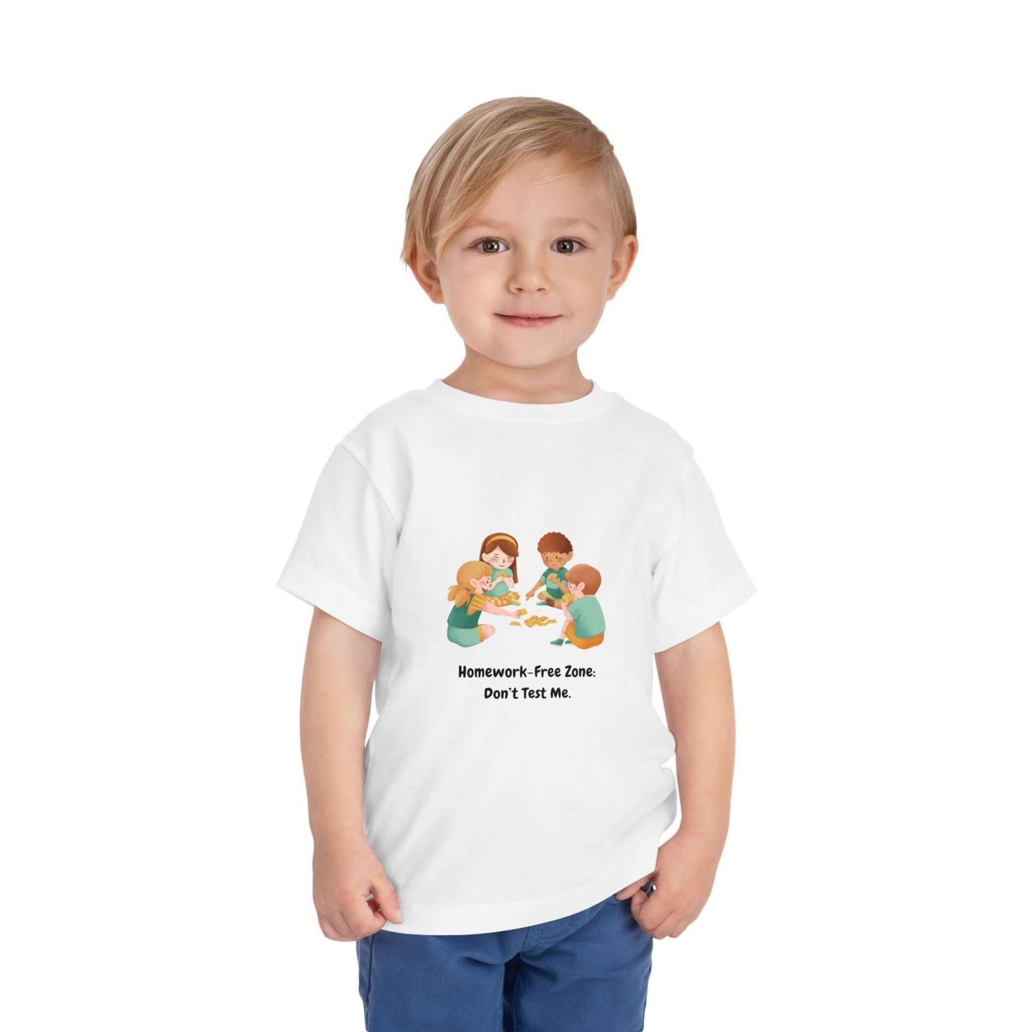 Toddler wearing a funny t-shirt saying 'Homework-Free Zone, Don't Test Me' with cartoon kids playing on the front.