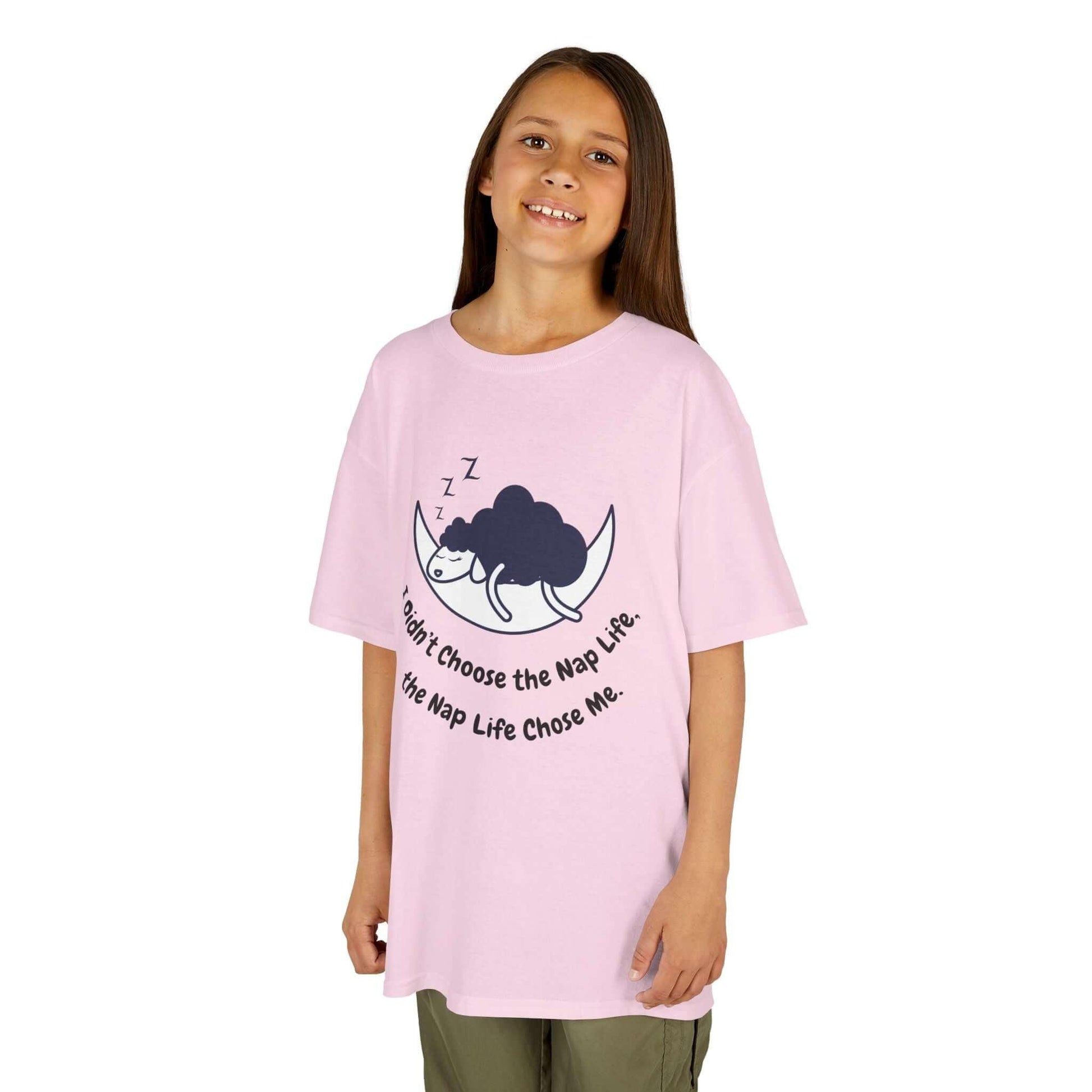 Kid wearing pink 'Nap Time: Funny T-Shirt for Kids' with playful print, 100% cotton, durable collar, seamless sides, perfect for everyday use.