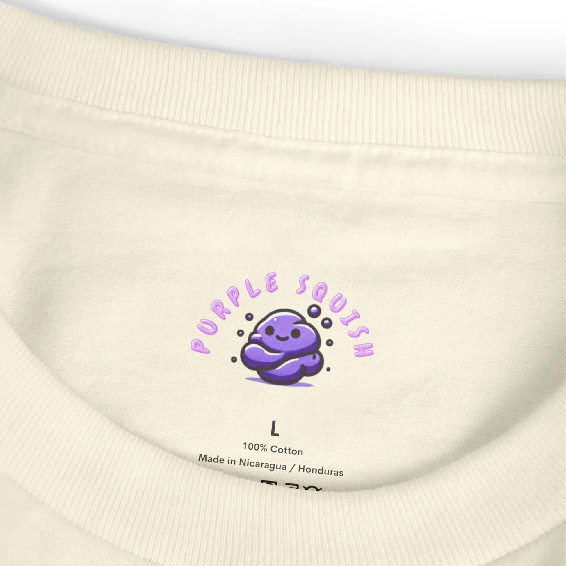 Collar view of a t-shirt with a "Purple Squish" logo, displaying a cute purple character, size label L, made of 100% cotton.