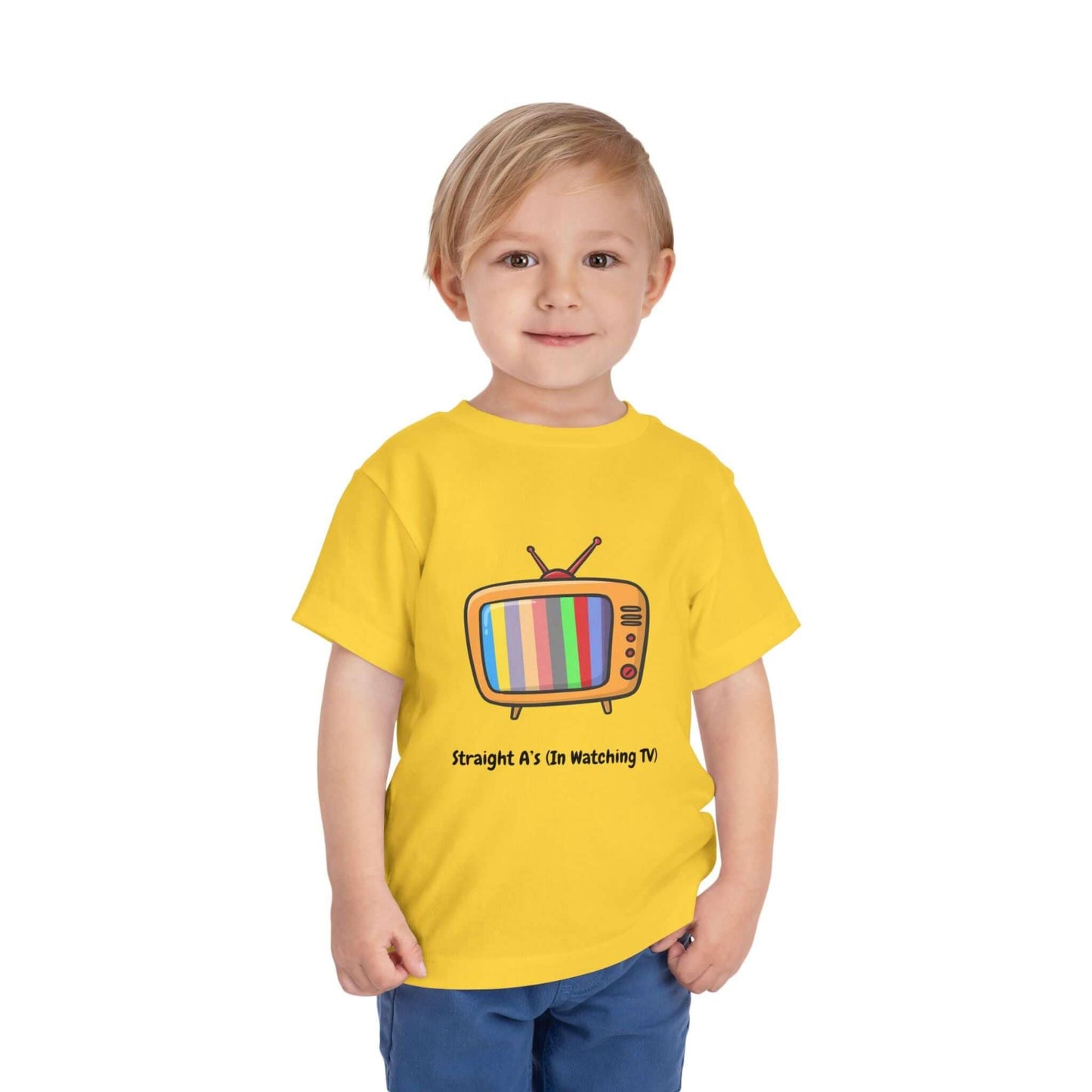 Toddler wearing a yellow "Straight A's in Watching TV" funny t-shirt with a colorful vintage TV graphic.