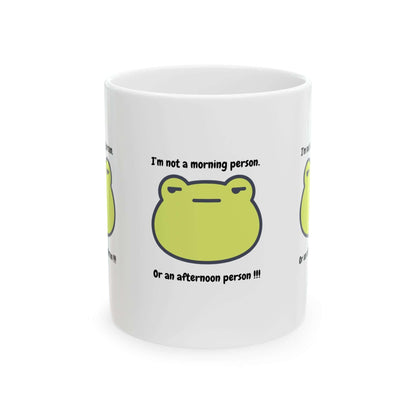 Ceramic mug with green frog design and funny text 'I'm not a morning person. Or an afternoon person.' Perfect gift coffee cup.