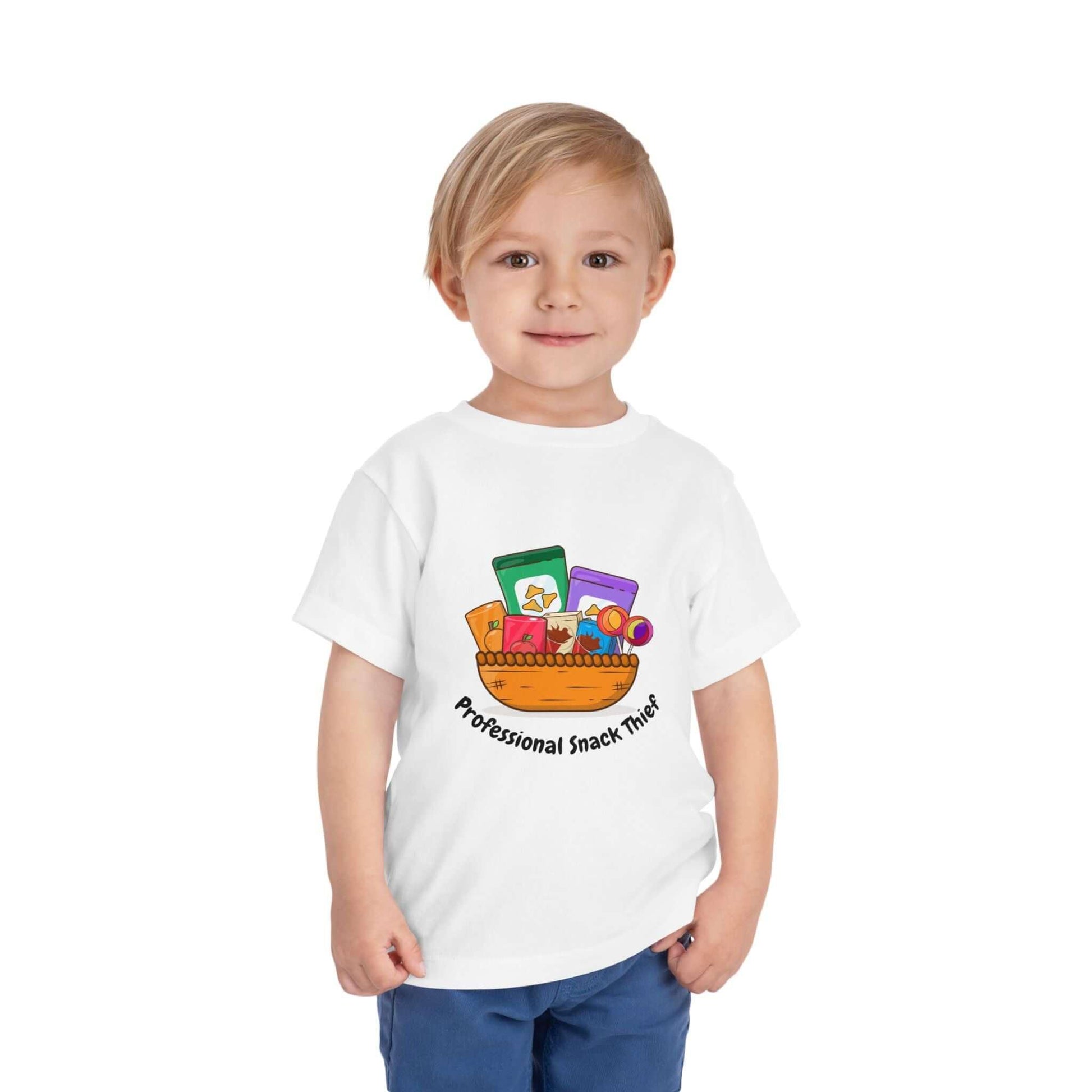 Toddler wearing a 'Professional Snack Thief' t-shirt with colorful snack graphics