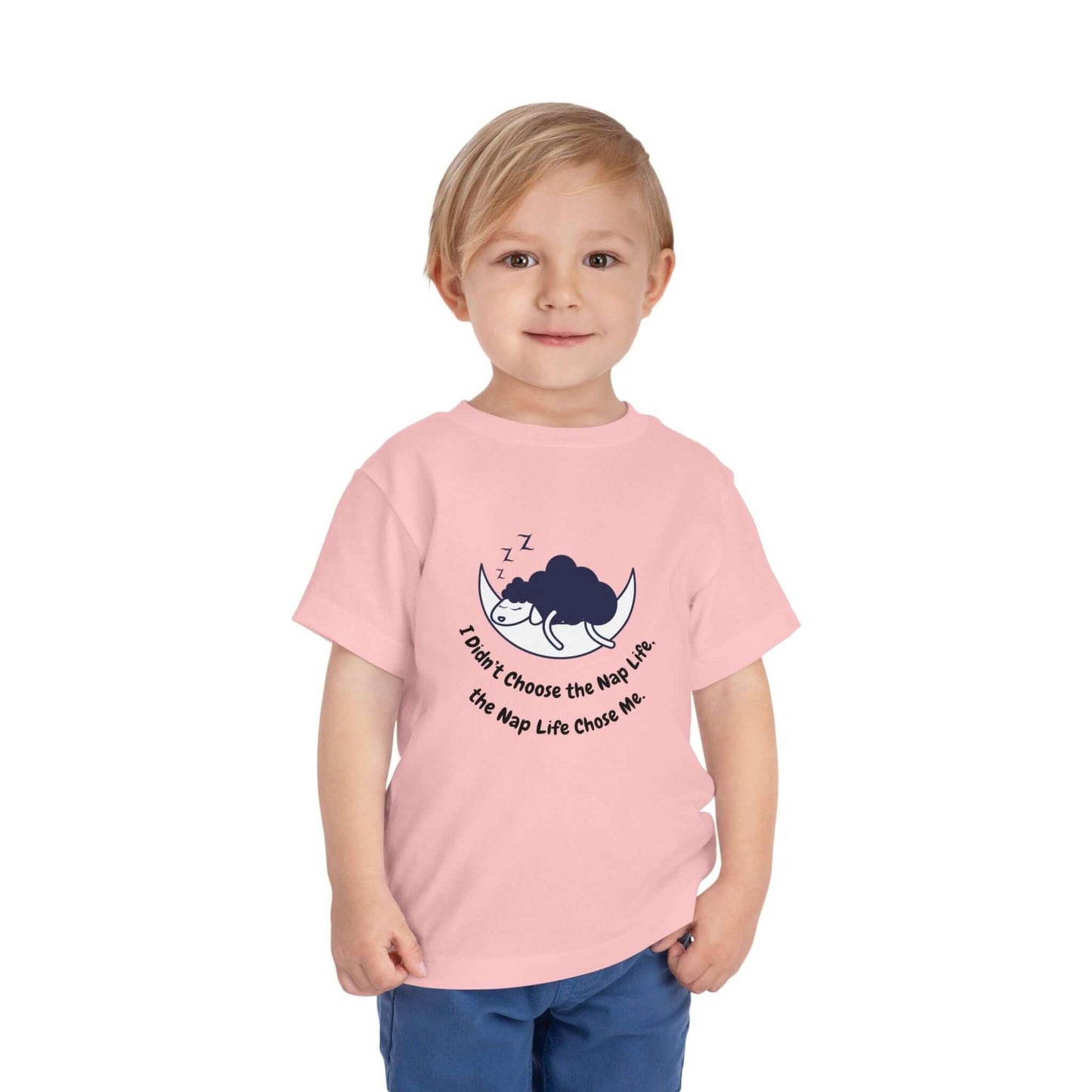 Toddler wearing a pink funny t-shirt with a nap-themed graphic, made of 100% Airlume cotton, ideal for kids' everyday wear.