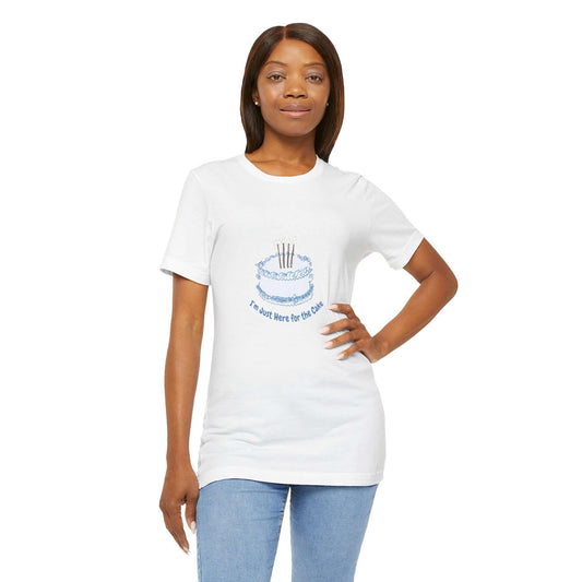 Woman wearing white t-shirt with "I'm Just Here for the Cake" design, featuring a blue cake graphic. Soft cotton, classic fit.