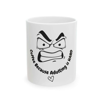 Funny ceramic mug with text 'Coffee Because Adulting is Hard' and angry face illustration, suitable for 11oz or 15oz sizes.