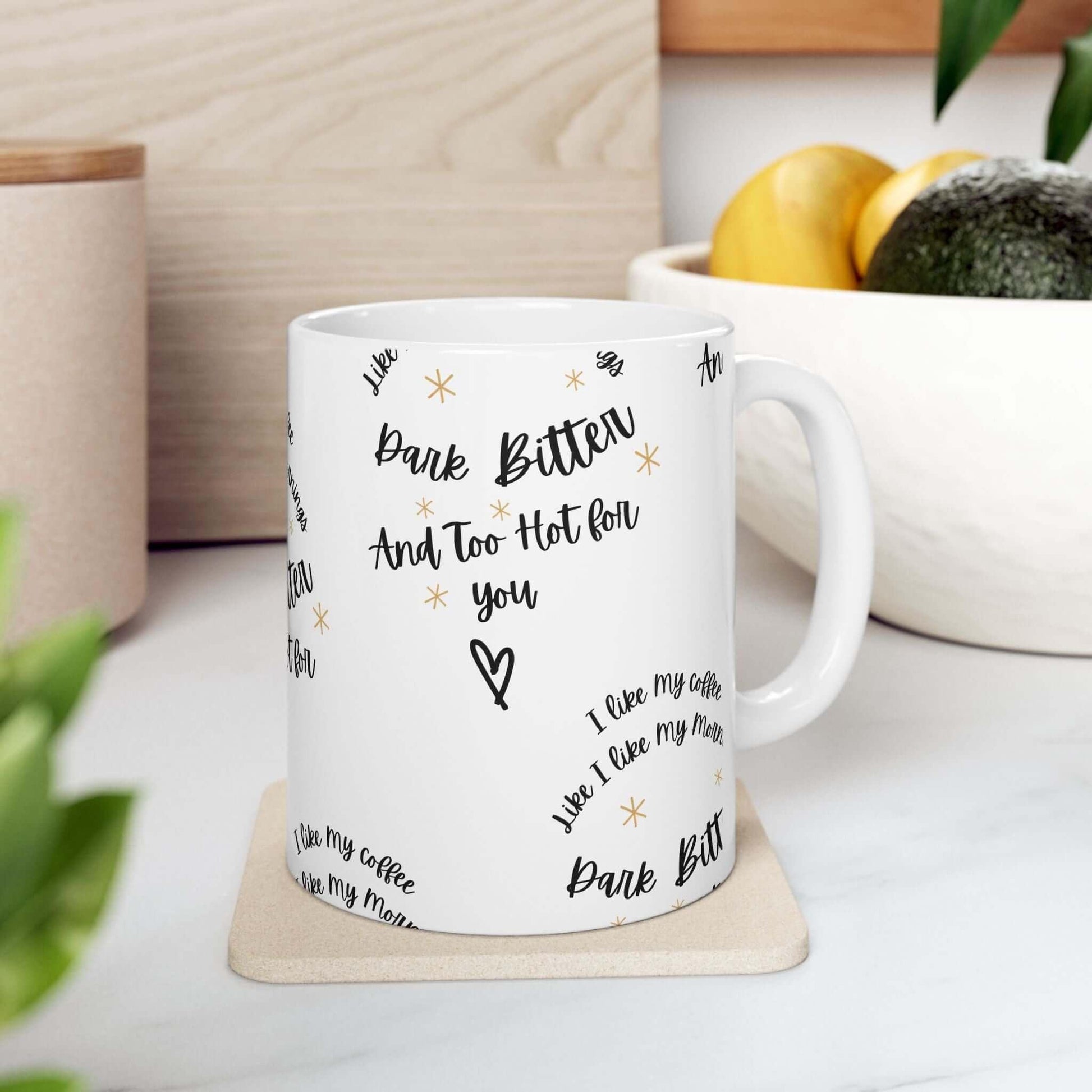 Funny ceramic coffee mug on kitchen counter, featuring humorous text 'Bark Bitter And Too Hot For You', available in 11oz and 15oz sizes.