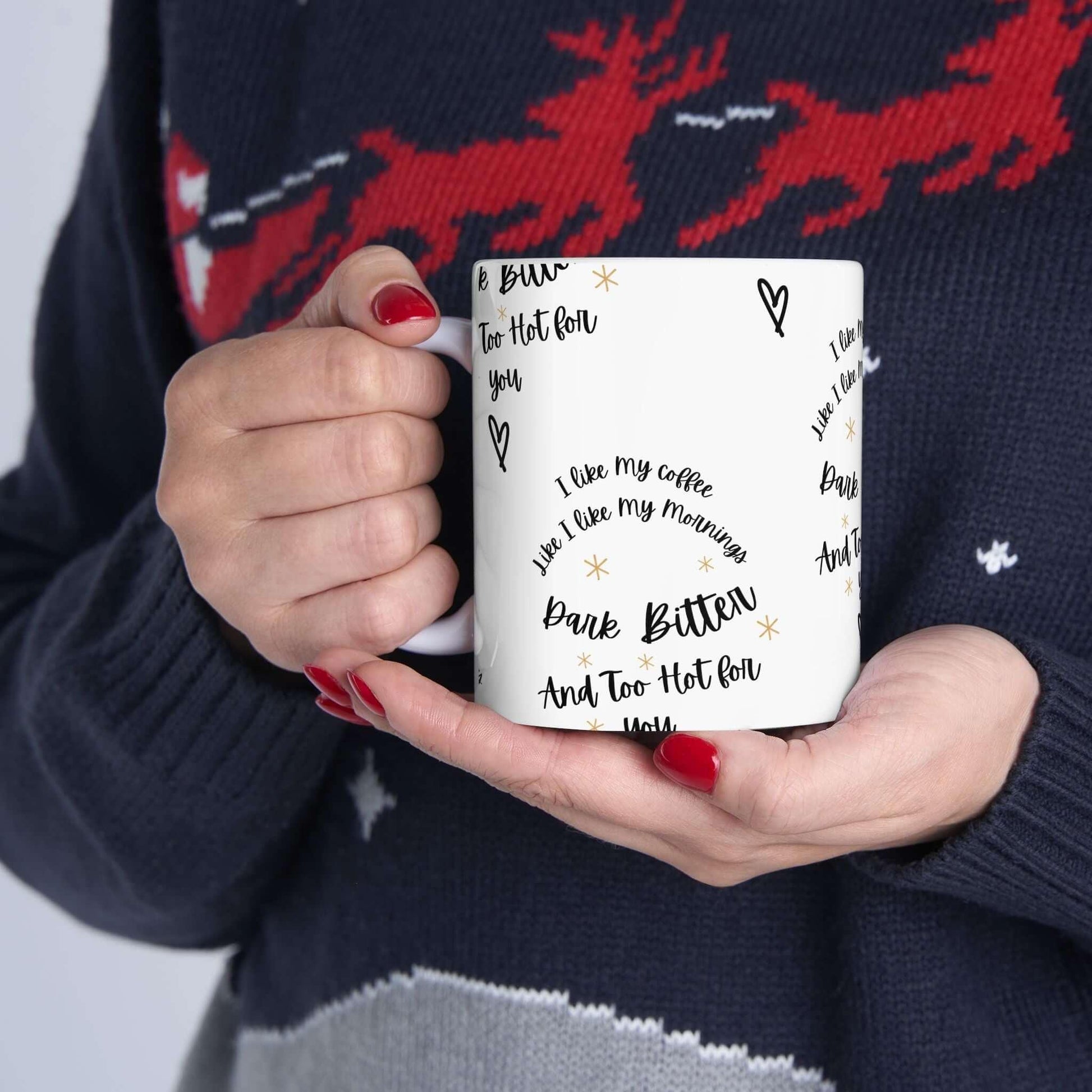 Person holding a white ceramic mug with funny coffee quotes, featuring durable, vivid designs; perfect gift for coffee lovers.