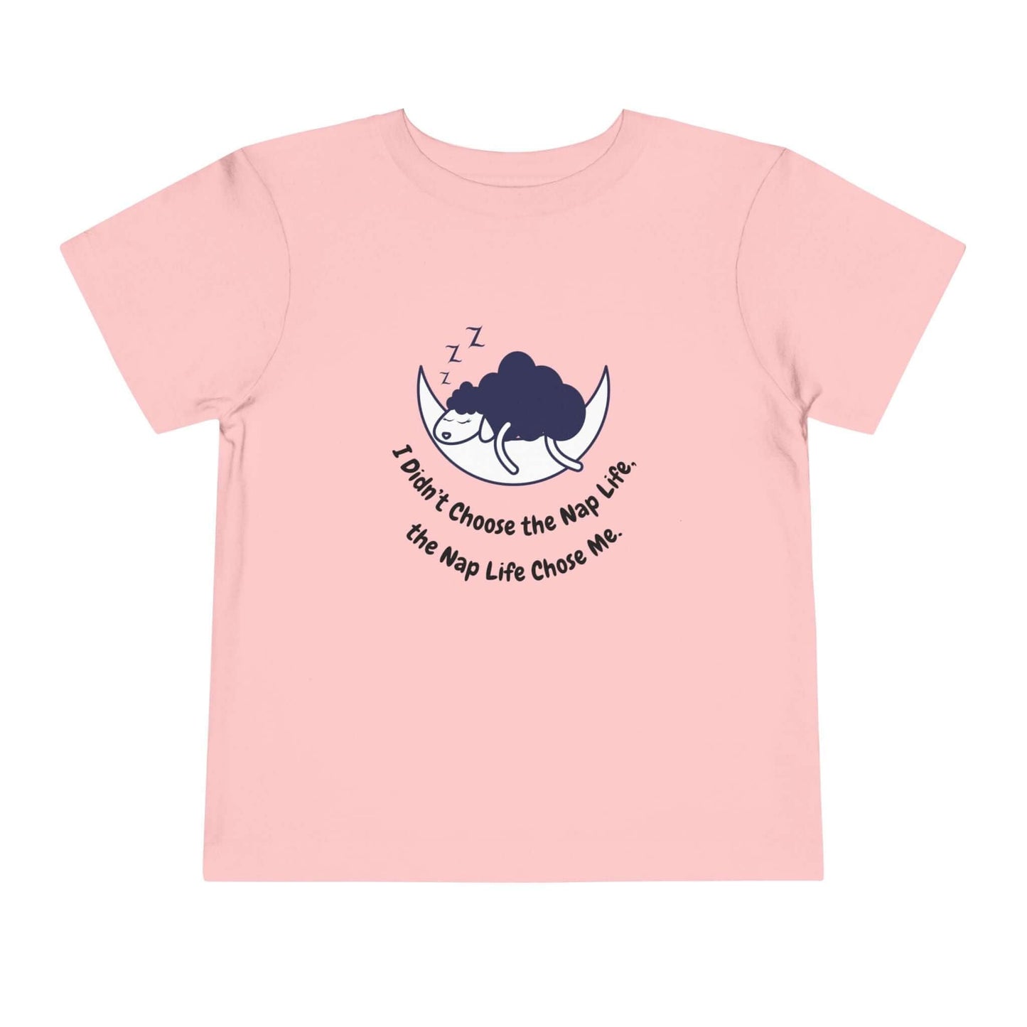 Toddler pink t-shirt with "I Didn't Choose the Nap Life, the Nap Life Chose Me" design, perfect for kids' wardrobe, 100% cotton.