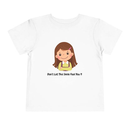 Funny toddler t-shirt reading 'Don't Let This Smile Fool You' with cartoon girl illustration, made of 100% Airlume cotton.